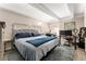 Comfortable bedroom features a large bed, a dedicated workspace, and ample natural light at 1265 Race St # 203, Denver, CO 80206
