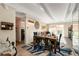 Open-concept dining room with a wooden table, blue accents, and access to a balcony at 1265 Race St # 203, Denver, CO 80206