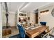 Cozy dining room features a rustic wood table, blue velvet chairs, and stylish lighting fixtures at 1265 Race St # 203, Denver, CO 80206