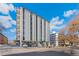 Modern condo building featuring a concrete parking area and a blue sky backdrop at 1265 Race St # 203, Denver, CO 80206
