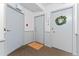 Hallway with three doors and neutral-colored decor in a condo complex at 1265 Race St # 203, Denver, CO 80206