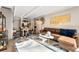 Open-concept living area features a dining table and a comfortable seating area with stylish decor at 1265 Race St # 203, Denver, CO 80206
