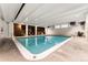 Indoor swimming pool with wood paneled accent wall and bright lighting at 1265 Race St # 203, Denver, CO 80206