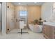 Modern bathroom featuring a glass-enclosed shower, soaking tub, and elegant fixtures at 10525 Sunshower Pl, Highlands Ranch, CO 80126