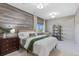 Cozy bedroom featuring a decorative wood accent wall and ample natural light at 10525 Sunshower Pl, Highlands Ranch, CO 80126