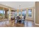 Bright dining area with access to a balcony, hardwood floors, and large windows with great views at 10525 Sunshower Pl, Highlands Ranch, CO 80126