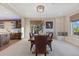 Bright dining room with a window seat, dark wood table and chairs, and decorative light fixture at 10525 Sunshower Pl, Highlands Ranch, CO 80126