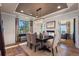 Elegant dining room with hardwood floors, fireplace, and a stylish chandelier and views at 10525 Sunshower Pl, Highlands Ranch, CO 80126