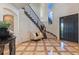 Grand foyer with a winding staircase, tile floors, and ample natural light at 10525 Sunshower Pl, Highlands Ranch, CO 80126