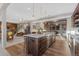 Beautiful kitchen with stainless steel appliances, wooden floors, a large island, and an open concept design at 10525 Sunshower Pl, Highlands Ranch, CO 80126