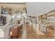 Sun-filled open floor plan with eat-in kitchen, hardwood flooring, and access to stairs at 10525 Sunshower Pl, Highlands Ranch, CO 80126
