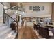 Bright and airy living space with an open staircase, gourmet kitchen, and hardwood flooring at 10525 Sunshower Pl, Highlands Ranch, CO 80126