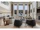 Spacious living room with high ceilings, large windows, and comfortable seating at 10525 Sunshower Pl, Highlands Ranch, CO 80126