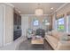 Living room with custom wet bar area, sofa, and neutral colors at 10525 Sunshower Pl, Highlands Ranch, CO 80126