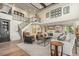 Open-concept living space with staircase, neutral colors, and plenty of seating at 10525 Sunshower Pl, Highlands Ranch, CO 80126