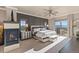Spacious main bedroom suite with a fireplace, scenic views, and a private outdoor balcony at 10525 Sunshower Pl, Highlands Ranch, CO 80126