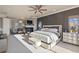 Relax in this spacious main bedroom with a fireplace, accent wall, and private outdoor balcony at 10525 Sunshower Pl, Highlands Ranch, CO 80126