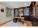 Private office with custom built-ins, natural light, and sleek desk at 10525 Sunshower Pl, Highlands Ranch, CO 80126