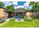 A well maintained yard with covered patio, grill, and mature landscaping at 1635 Poplar St, Denver, CO 80220