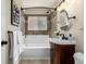 Bathroom with vanity, tile surround, and a bathtub at 1635 Poplar St, Denver, CO 80220