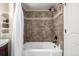 Bathroom showcasing bathtub, tile surround, and white shower curtain at 1635 Poplar St, Denver, CO 80220