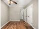 Bedroom featuring hardwood floors, neutral paint, closet and an ensuite bathroom at 1635 Poplar St, Denver, CO 80220