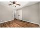 Bedroom showcasing hardwood floors, neutral paint, closet and a ceiling fan at 1635 Poplar St, Denver, CO 80220