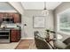 Inviting dining room adjacent to kitchen with modern light fixture and table setting at 1635 Poplar St, Denver, CO 80220