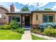 Lovely brick home showcases fresh landscaping and a welcoming front entrance at 1635 Poplar St, Denver, CO 80220