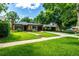 Inviting home with a well-maintained lawn, mature trees, and a private driveway at 1635 Poplar St, Denver, CO 80220