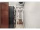 Hallway featuring in-unit washer and dryer, wood and tile flooring, and access to other rooms at 1635 Poplar St, Denver, CO 80220
