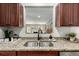 Kitchen area looking to the living room and showcasing a stainless sink and faucet at 1635 Poplar St, Denver, CO 80220