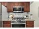 Close-up of kitchen featuring a stainless steel stove and microwave at 1635 Poplar St, Denver, CO 80220
