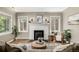 Elegant living room featuring a white brick fireplace, hardwood floors, and classic design at 1635 Poplar St, Denver, CO 80220