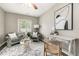 Bright and airy living room features comfortable seating, modern decor, and large window at 1635 Poplar St, Denver, CO 80220