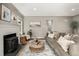 Comfortable living room with a cozy fireplace, hardwood floors, and a relaxing ambiance at 1635 Poplar St, Denver, CO 80220