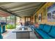 Covered patio with brick exterior, grill, outdoor furniture and a view of the backyard at 1635 Poplar St, Denver, CO 80220