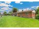 Exterior of home with large, lush lawn and brick facade at 5645 W 5Th Ave # 5645 & 5655, Lakewood, CO 80226