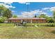 Spacious backyard featuring partial fencing with some outdoor equipment and greenery at 5645 W 5Th Ave # 5645 & 5655, Lakewood, CO 80226