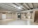 Spacious unfinished basement with exposed ceiling and laundry appliances at 5645 W 5Th Ave # 5645 & 5655, Lakewood, CO 80226