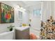 Fresh bathroom with stylish vanity, framed mirror, and shower with colorful curtain at 5645 W 5Th Ave # 5645 & 5655, Lakewood, CO 80226