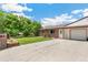 Lovely single-story duplex featuring well-maintained lawn, brick exterior, and a driveway with a garage at 5645 W 5Th Ave # 5645 & 5655, Lakewood, CO 80226