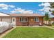 Inviting duplex with a well-kept lawn, brick exterior, and charming front yard decor at 5645 W 5Th Ave # 5645 & 5655, Lakewood, CO 80226