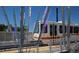 Modern light rail train glides through the station, offering convenient transportation access and reflecting contemporary urban transit at 5645 W 5Th Ave # 5645 & 5655, Lakewood, CO 80226