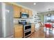 Kitchen featuring stainless steel appliances, light wood cabinets, and hardwood floors at 7958 S Algonquian Ct, Aurora, CO 80016