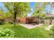 Landscaped backyard featuring a pergola with outdoor seating and string lights, perfect for entertaining at 1226 Dexter St, Denver, CO 80220