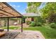 Backyard featuring an ivy covered garage/carriage house and pergola at 1226 Dexter St, Denver, CO 80220