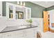Elegant bathroom showcasing a vanity with drawers and cabinets, and a well lit mirror at 1226 Dexter St, Denver, CO 80220