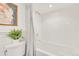 Clean, modern bathroom showcasing a soaking tub, fresh white tiles, and a minimalist aesthetic for a spa-like experience at 1226 Dexter St, Denver, CO 80220