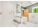 Bright bathroom featuring a frameless shower, gray tile, and a well-lit design at 1226 Dexter St, Denver, CO 80220
